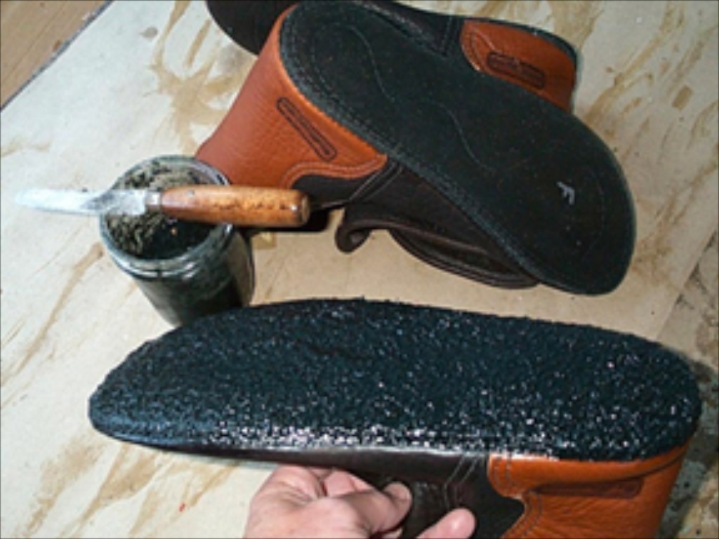 applying goop to leather moccasins soles