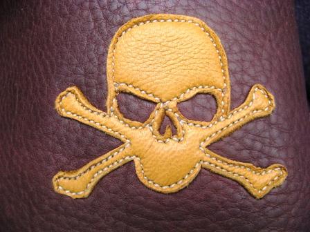 gold skull crossbones leather artwork